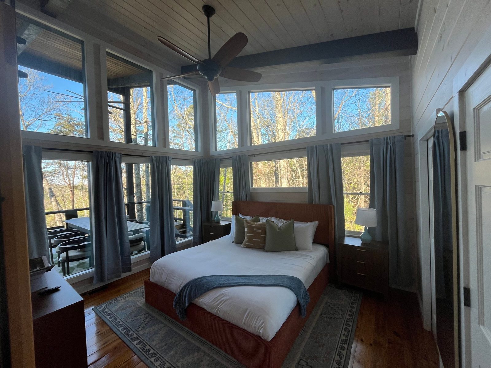 Airbnb cabin bedroom with window walls overlooking the North Georgia mountains
