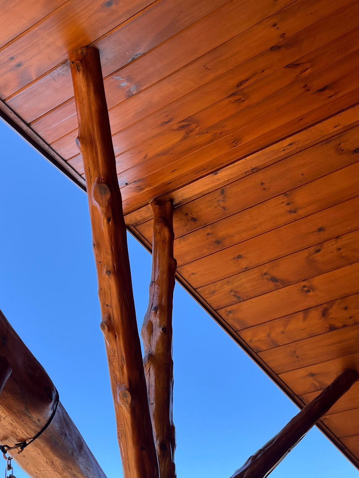 Clean tongue-and-groove porch ceiling on a Blue Ridge cabin after exterior cleaning