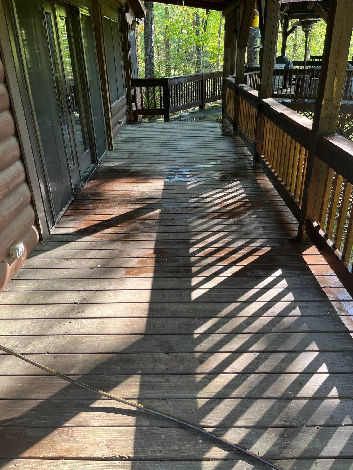 Faded gray deck boards on a Cherry Log, GA cabin before rebuild and staining