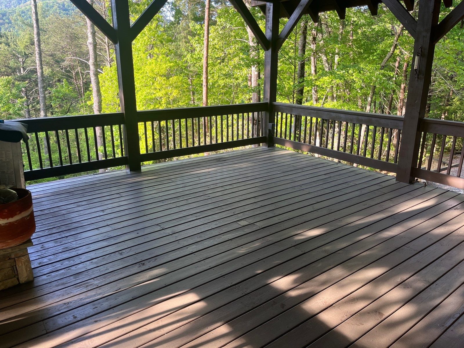 Stained open deck and covered outdoor living area at a Cherry Log cabin
