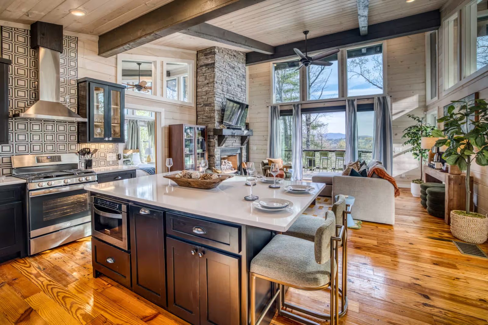 Black cabinetry and kitchen island against whitewashed pine walls in a Morganton cabin
