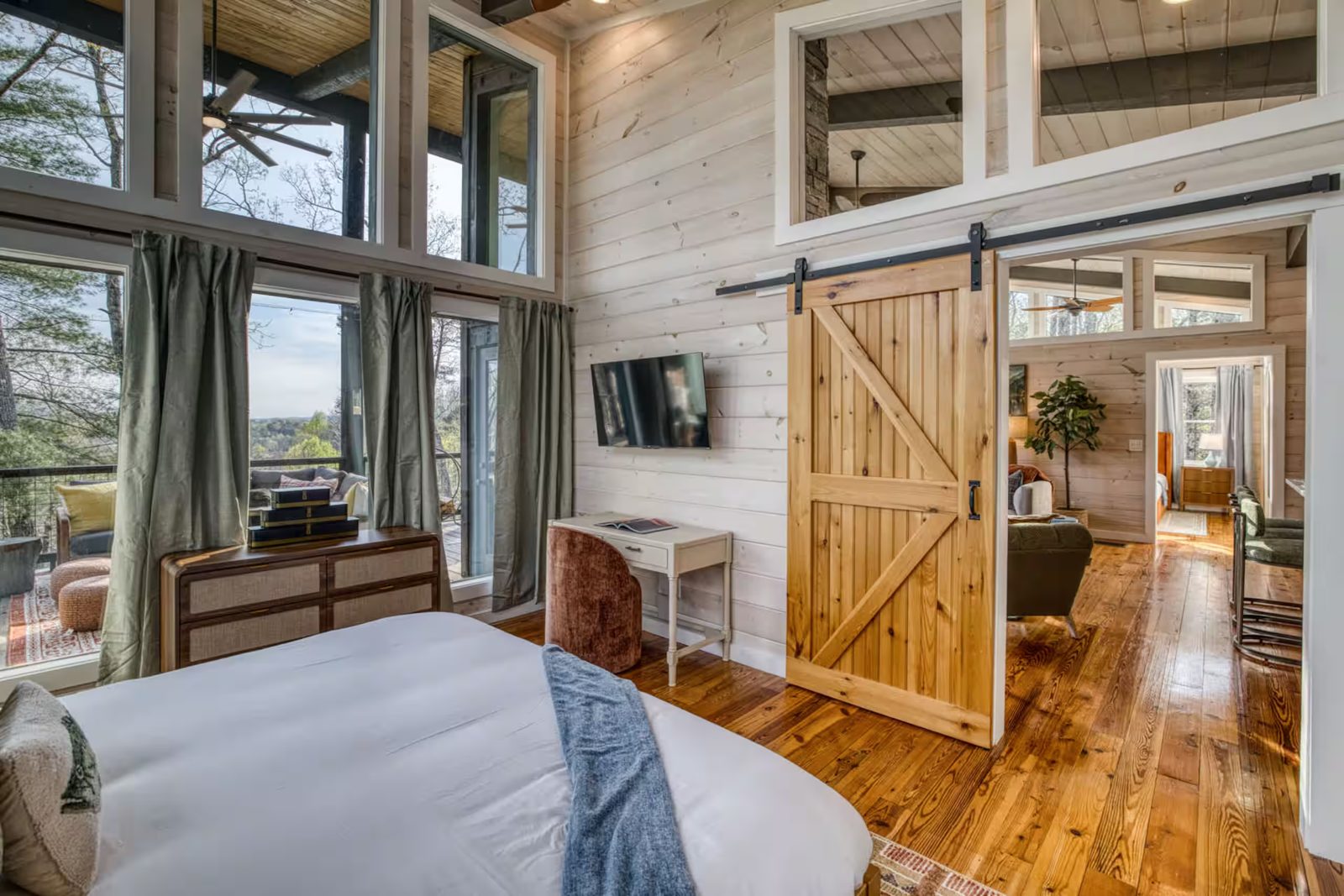 Whitewashed shiplap bedroom wall with cedar barn door in a Morganton cabin