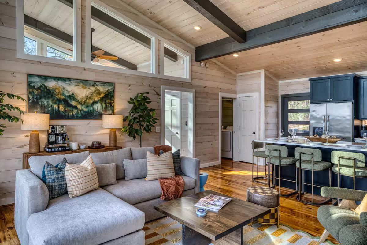 Whitewashed pine living room wall with mountain artwork in a Morganton Airbnb cabin